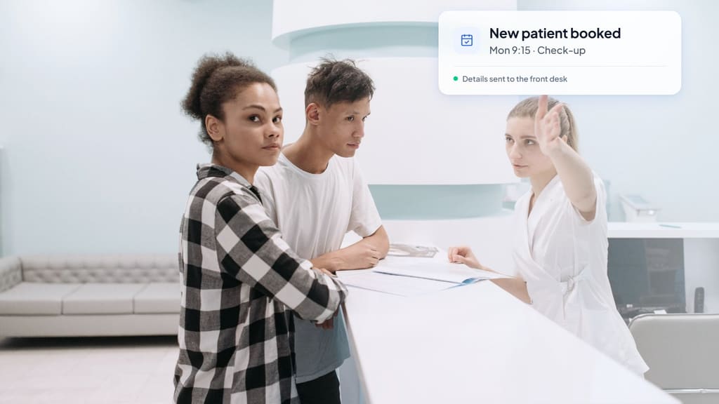 Receptionist at a bright clinic front desk helping two patients, with a card showing a new patient check-up booked for Monday at 9:15