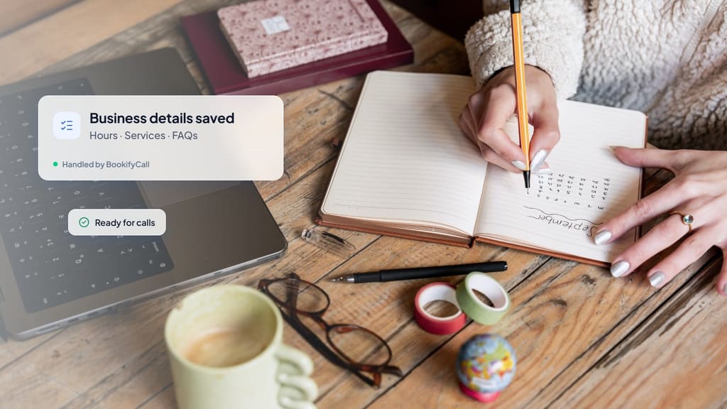 Hands writing notes in a notebook beside a laptop and coffee, with a card showing business details saved: hours, services and FAQs